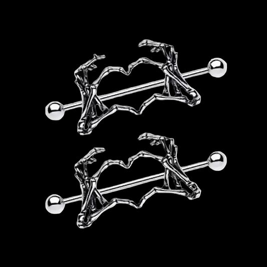 Skeleton hand heart nipple piercings